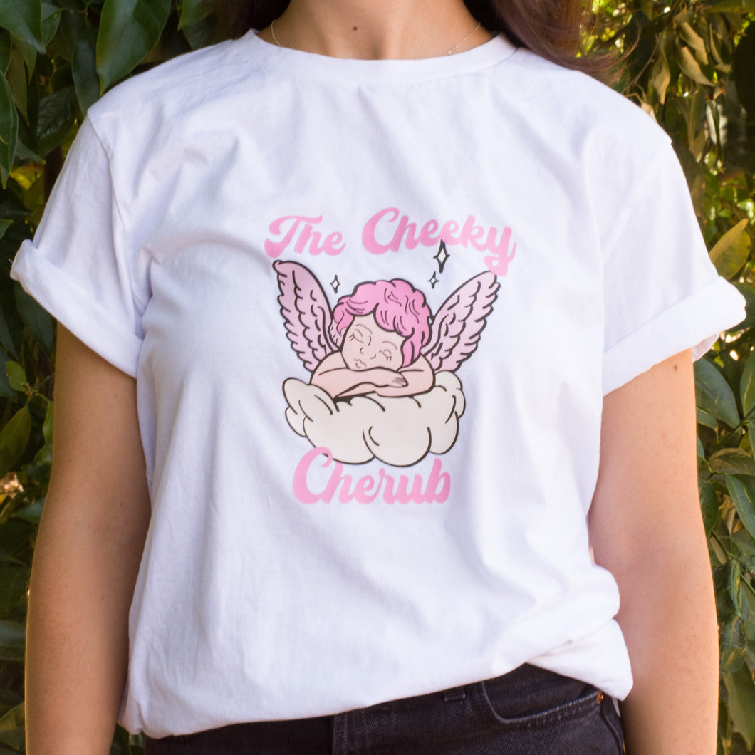 Crisp White T shirt with a cherub with pink wings and hair. The words 'The Cheeky Cherub' are written in hot pink letters. 