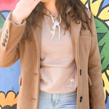 Load image into Gallery viewer, Model wearing a trench coat and tan sweater 
