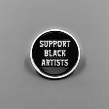 Load image into Gallery viewer, Black enamel pin with the words &#39;Support Black Artists&quot; written in white letters
