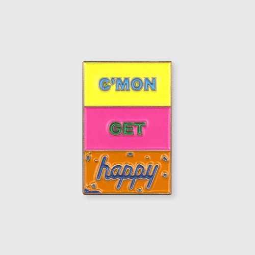 Color blocked enamel pin with the colors yellow, pink, and orange in the background with the words 'C'mon Get Happy