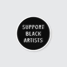 Load image into Gallery viewer, Black enamel pin with the words &#39;Support Black Artists&quot; written in white letters
