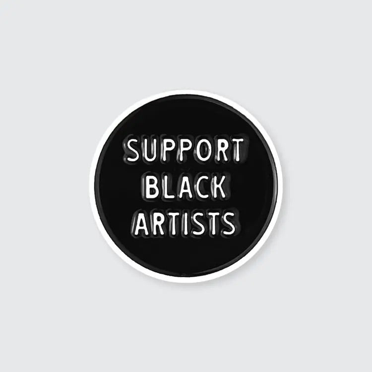 Black enamel pin with the words 'Support Black Artists