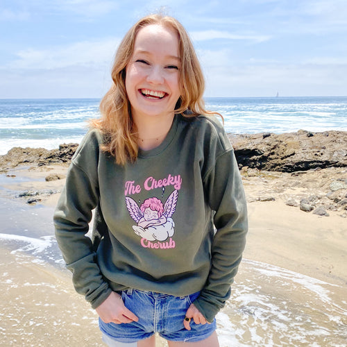 Girl wearing sweatshirt on the beach with an angel logo 